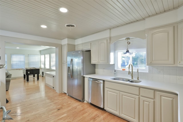 kitchen featuring plenty of natural light, hanging light fixtures, sink, and appliances with stainless steel finishes