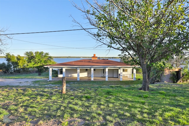 back of property featuring a porch and a yard