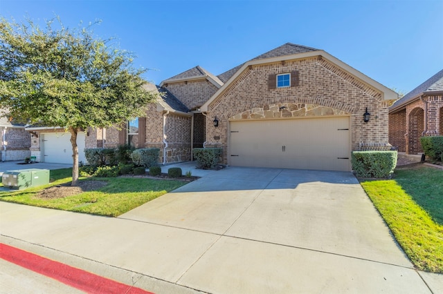 view of front of home with a garage and a front lawn