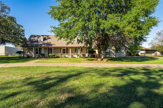 view of front facade featuring covered porch and a front yard