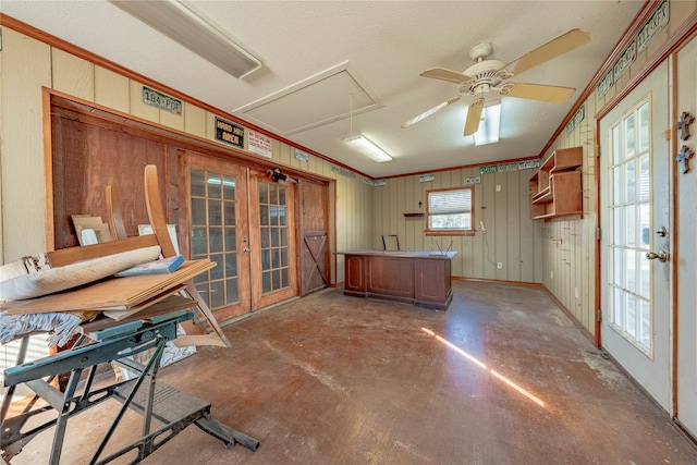 kitchen featuring french doors, concrete flooring, a textured ceiling, ceiling fan, and crown molding