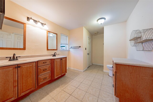 bathroom with tile patterned floors, vanity, and toilet