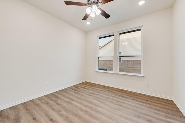 spare room with light wood-type flooring, baseboards, a ceiling fan, and recessed lighting