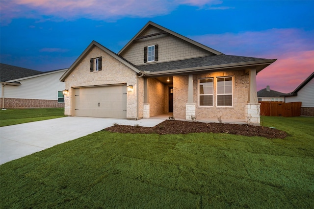 view of front facade with driveway, brick siding, a garage, and a yard