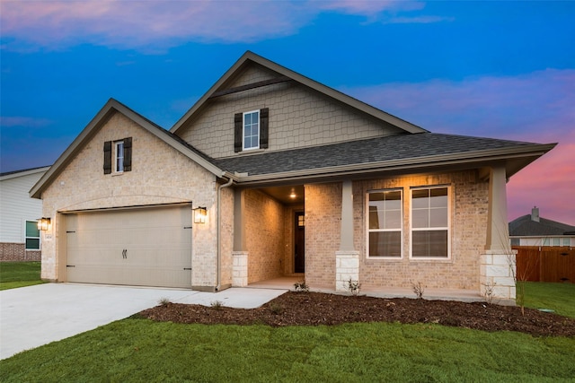 view of front of house featuring roof with shingles, brick siding, concrete driveway, a lawn, and a garage