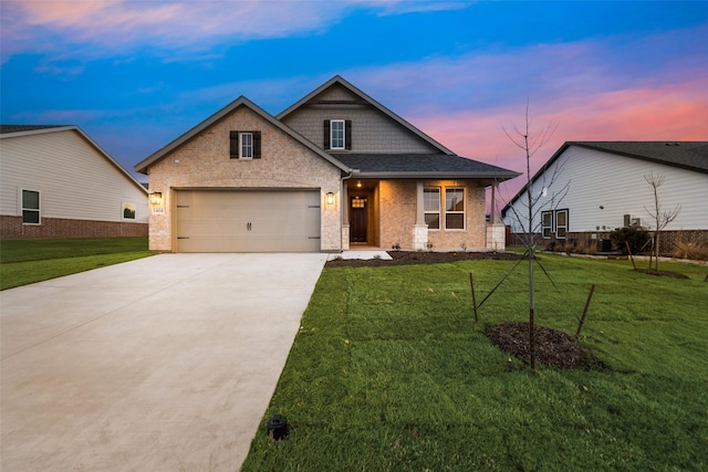 view of front of property with a front yard, brick siding, driveway, and an attached garage