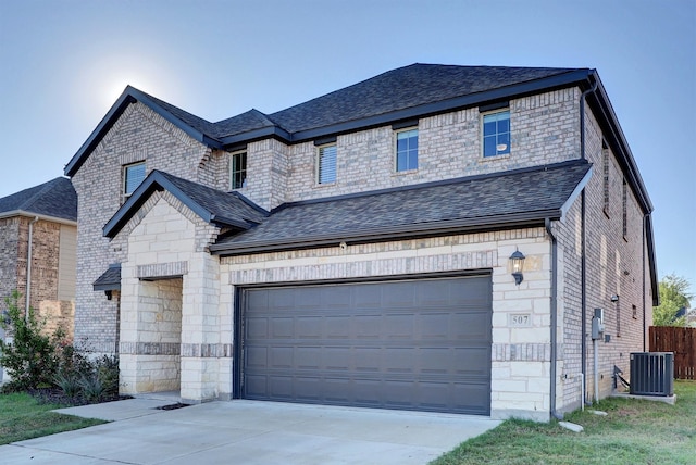 view of front facade featuring central AC and a garage