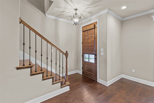 entrance foyer featuring crown molding, dark hardwood / wood-style flooring, and a notable chandelier