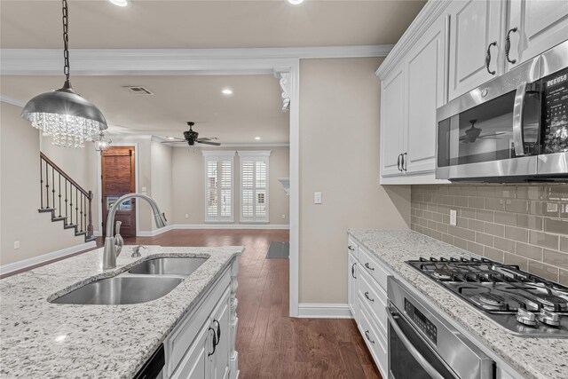 kitchen with stainless steel appliances, white cabinetry, dark hardwood / wood-style floors, and sink