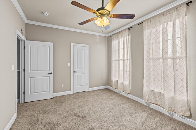 unfurnished bedroom with carpet flooring, ceiling fan, and ornamental molding