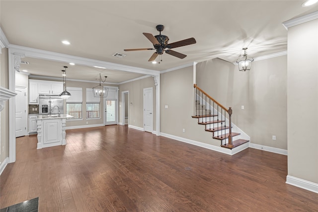 unfurnished living room featuring crown molding, ceiling fan, and dark wood-type flooring