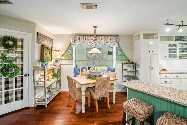 dining space featuring dark wood-type flooring