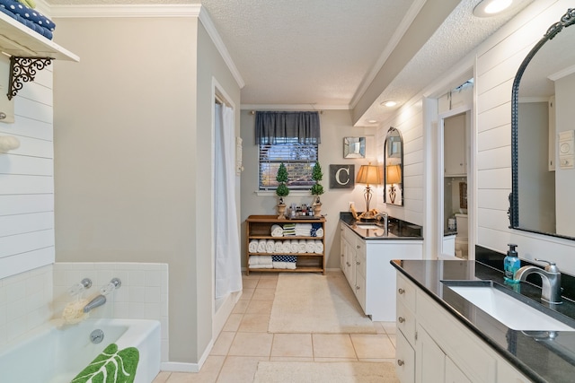 bathroom featuring tile patterned floors, crown molding, vanity, and a textured ceiling