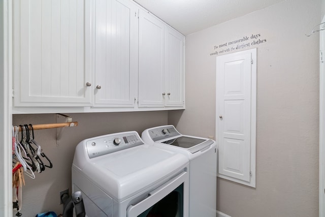 clothes washing area with cabinets, a textured ceiling, and washing machine and dryer