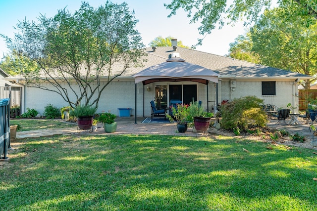 back of property featuring a gazebo, a yard, and a patio