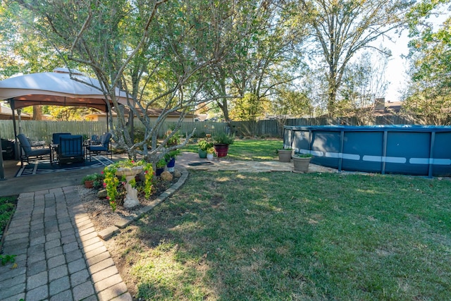 view of yard featuring a gazebo, a patio area, and a fenced in pool