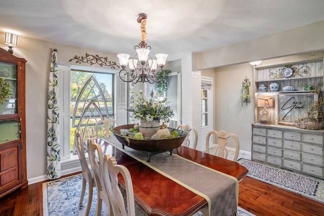 dining room featuring a chandelier and dark wood-type flooring