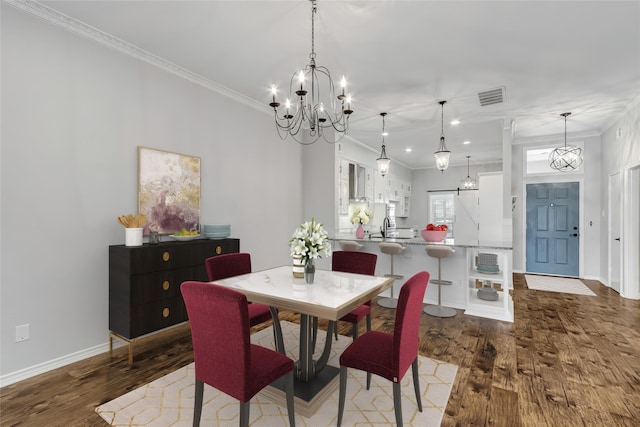 dining area featuring sink, dark hardwood / wood-style flooring, and ornamental molding