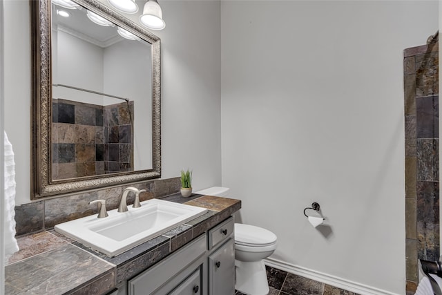 bathroom with vanity, crown molding, tile patterned flooring, toilet, and walk in shower