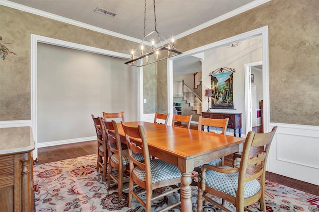 dining space featuring hardwood / wood-style flooring and crown molding