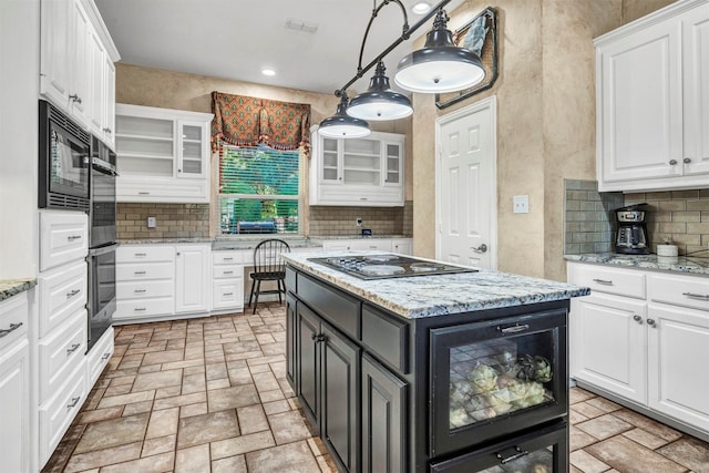 kitchen with white cabinetry, a kitchen island, pendant lighting, and black appliances