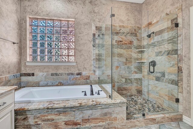 bathroom featuring vanity and shower with separate bathtub