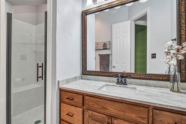 bathroom featuring an enclosed shower and vanity