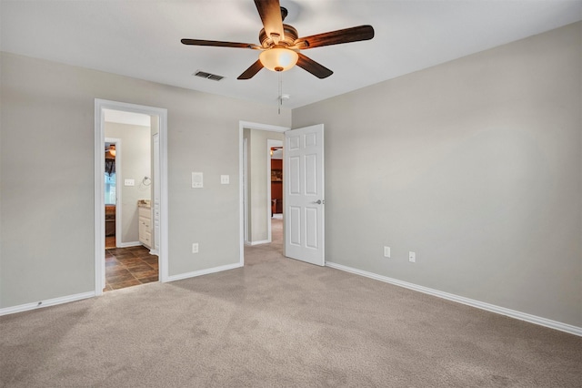 unfurnished bedroom featuring connected bathroom and ceiling fan