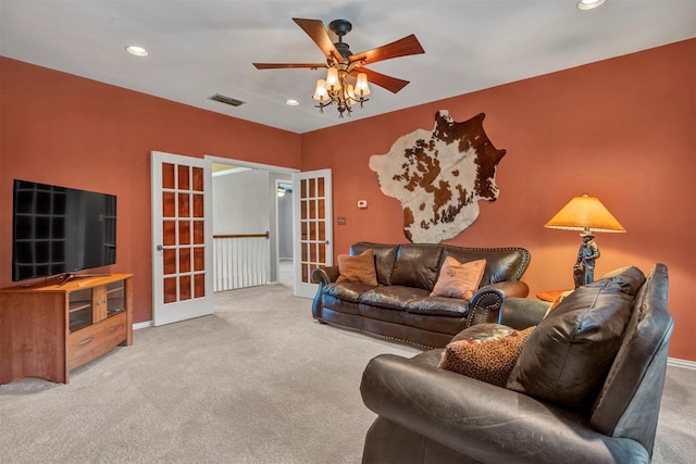 living room featuring carpet floors, french doors, and ceiling fan