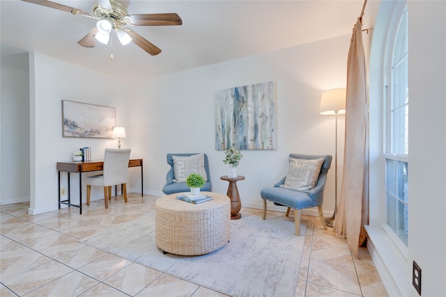 sitting room featuring ceiling fan