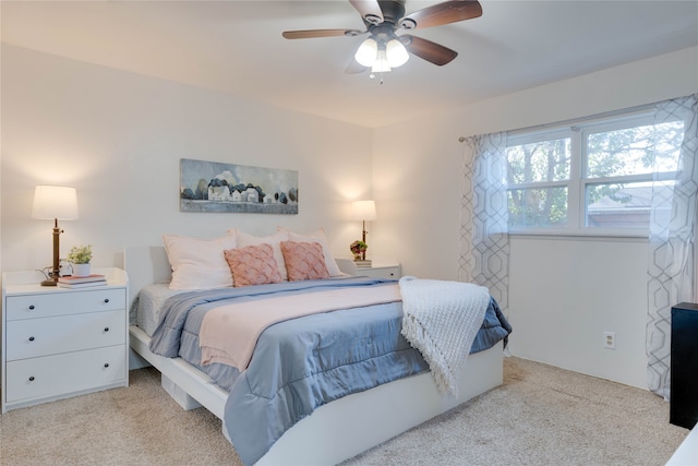 bedroom featuring ceiling fan and light carpet