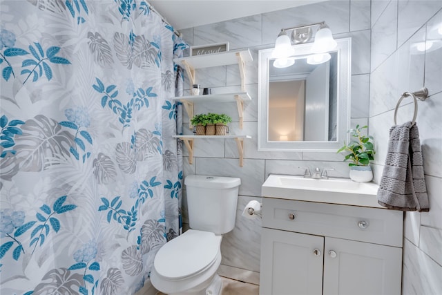 bathroom featuring vanity, tile patterned flooring, toilet, tile walls, and curtained shower