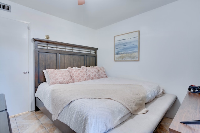 tiled bedroom featuring ceiling fan