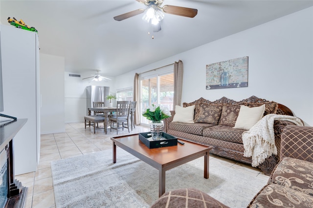 living room with ceiling fan and light tile patterned floors