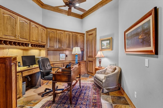 office space featuring a towering ceiling, built in desk, ceiling fan, and crown molding