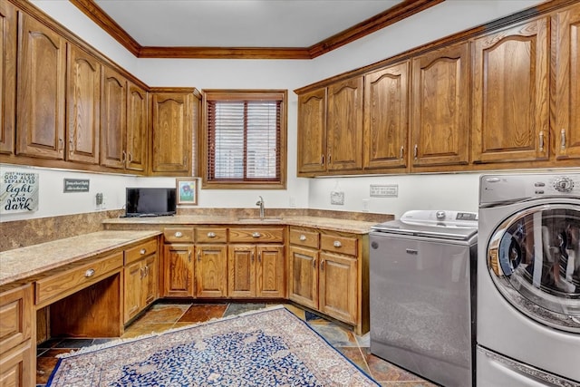 laundry room with cabinets, independent washer and dryer, ornamental molding, and sink