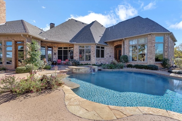 view of pool featuring an in ground hot tub