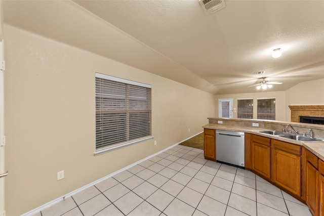 kitchen featuring stainless steel dishwasher, ceiling fan, sink, and a textured ceiling