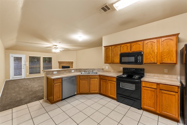 kitchen with ceiling fan, sink, kitchen peninsula, light carpet, and black appliances