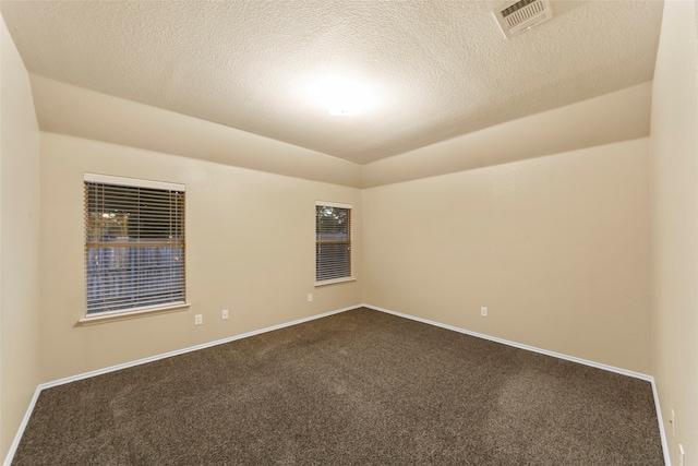 carpeted spare room with a textured ceiling