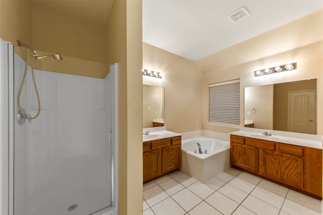 bathroom with tile patterned flooring, shower with separate bathtub, and vanity