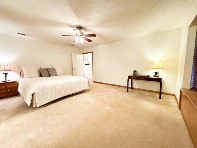 bedroom with carpet flooring, ceiling fan, and a textured ceiling