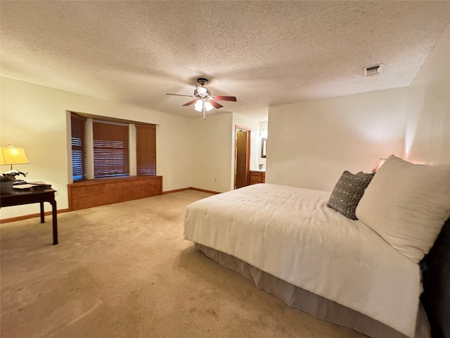 bedroom with carpet flooring, ceiling fan, and a textured ceiling