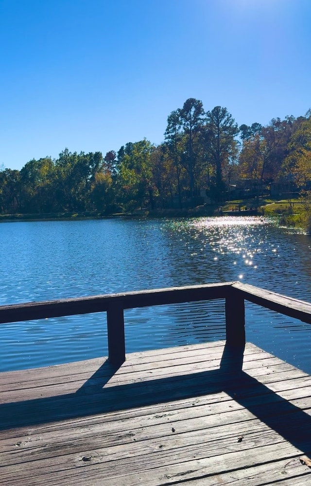 view of dock with a deck with water view