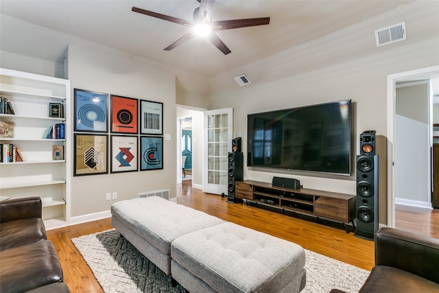 living room with light hardwood / wood-style flooring and ceiling fan