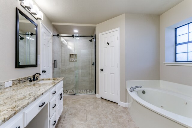 bathroom with tile patterned flooring, shower with separate bathtub, and vanity