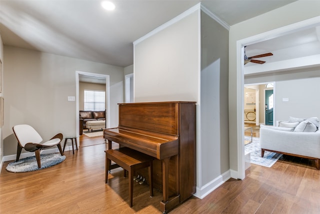 misc room with light wood-type flooring and ceiling fan