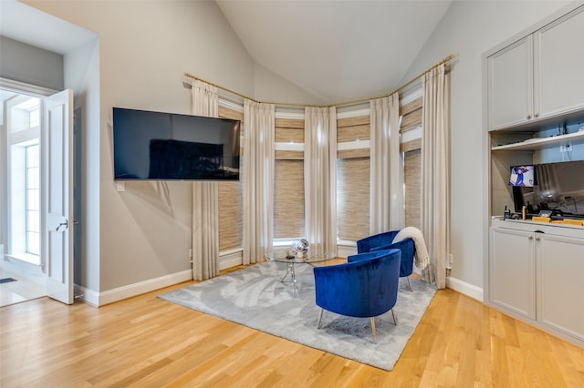 sitting room featuring light hardwood / wood-style flooring and lofted ceiling