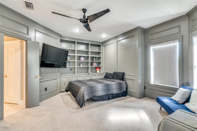 bedroom featuring ceiling fan, light colored carpet, and multiple windows