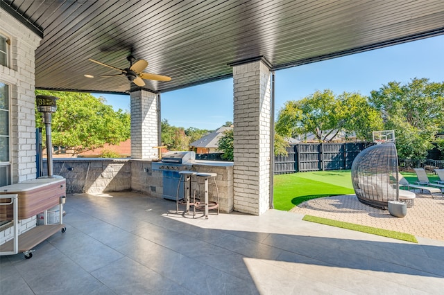 view of patio with an outdoor bar, ceiling fan, exterior kitchen, and a grill